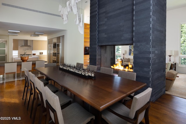 344 Beaver Dam Rd, Vail, CO 81657 - dining space with wood finished floors, a wall mounted AC, and a multi sided fireplace