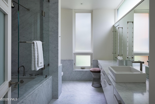 344 Beaver Dam Rd, Vail, CO 81657 - bathroom with vanity, a garden tub, tile walls, a marble finish shower, and a wainscoted wall