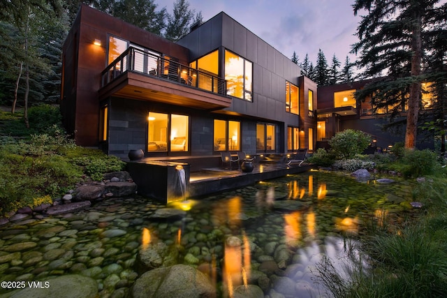 344 Beaver Dam Rd, Vail, CO 81657 - back of property at dusk featuring a balcony