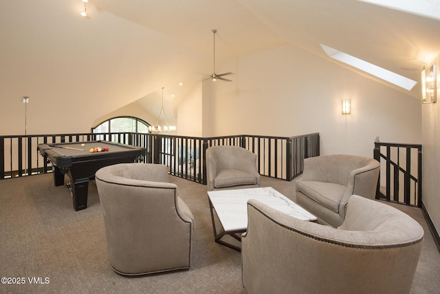 living area with an inviting chandelier, carpet flooring, a skylight, and high vaulted ceiling