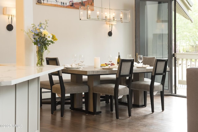 dining space with dark hardwood / wood-style flooring