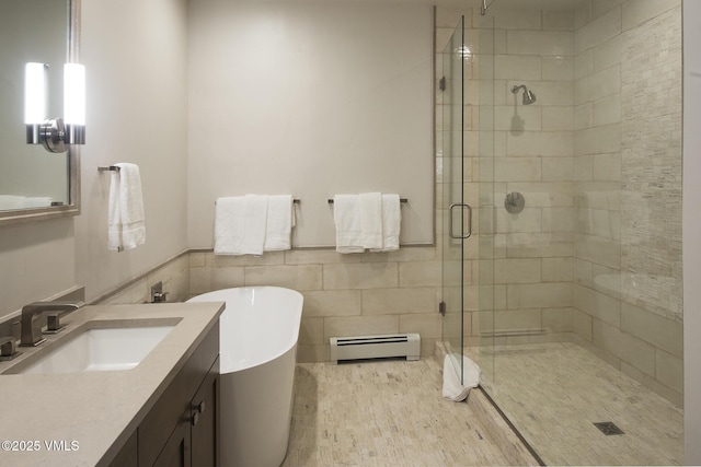 bathroom with a baseboard radiator, separate shower and tub, and vanity