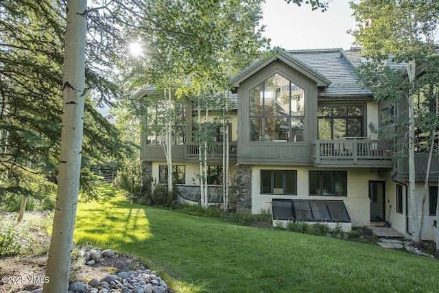 rear view of property featuring a yard