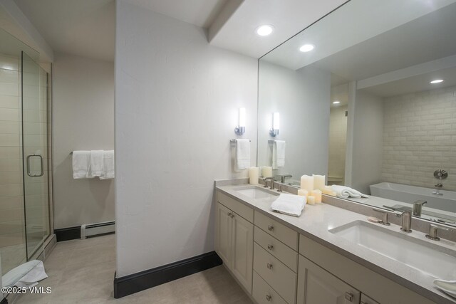 bathroom with vanity, shower with separate bathtub, and baseboard heating