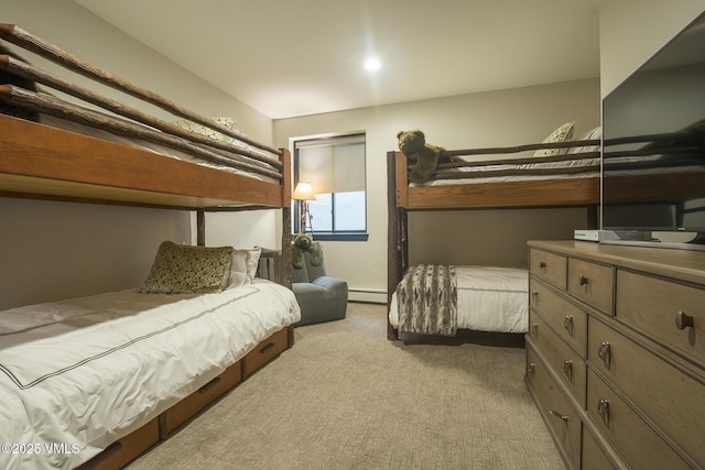 bedroom with light colored carpet and baseboard heating