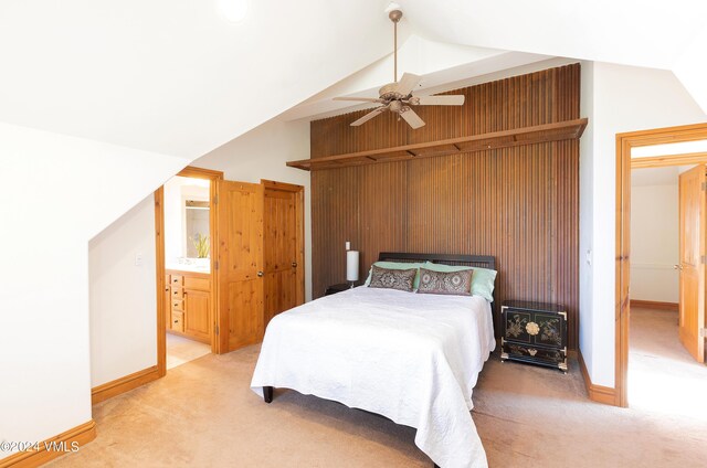 bedroom with ceiling fan, light colored carpet, and vaulted ceiling