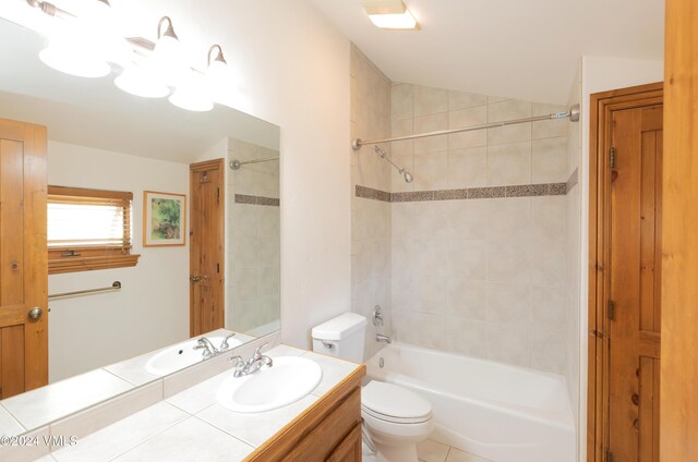 full bathroom featuring vanity, toilet, and tiled shower / bath combo