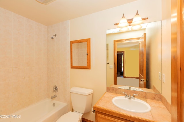 full bathroom with vanity, toilet, and tiled shower / bath