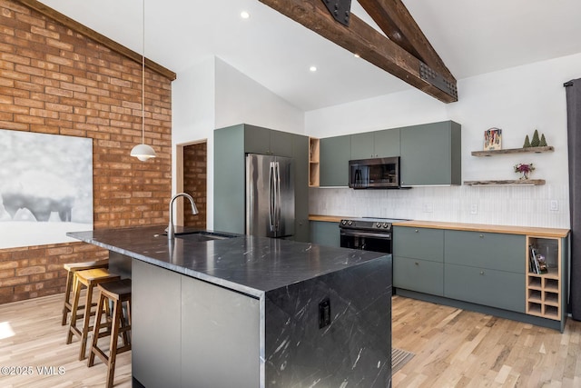 kitchen featuring open shelves, stainless steel appliances, light wood-style floors, a sink, and beamed ceiling