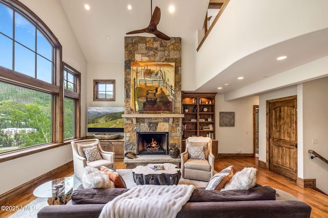 2417 Garmisch Dr Unit B, Vail, CO 81657 - living room featuring a stone fireplace, high vaulted ceiling, wood finished floors, and recessed lighting