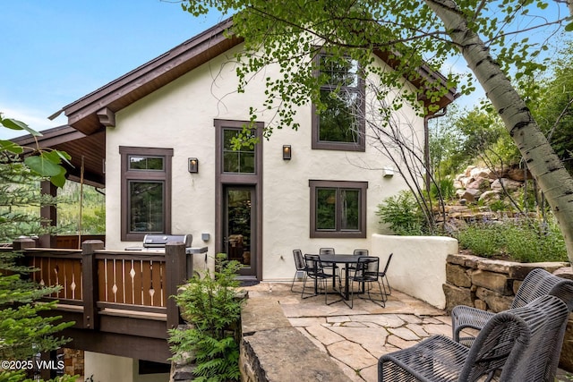 2417 Garmisch Dr Unit B, Vail, CO 81657 - rear view of house featuring stucco siding, a patio area, and outdoor dining space