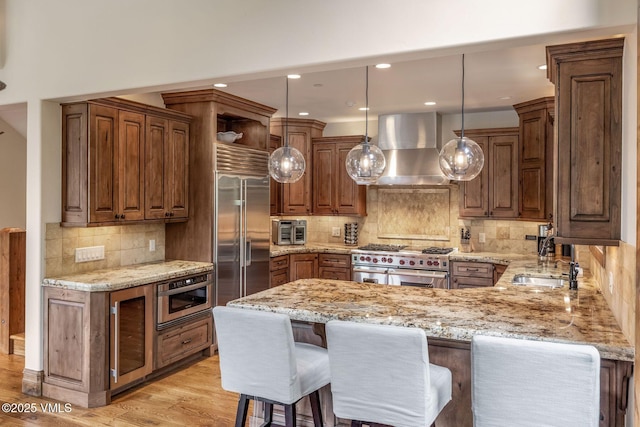 2417 Garmisch Dr Unit B, Vail, CO 81657 - kitchen featuring a peninsula, backsplash, light stone countertops, wine cooler, and recessed lighting