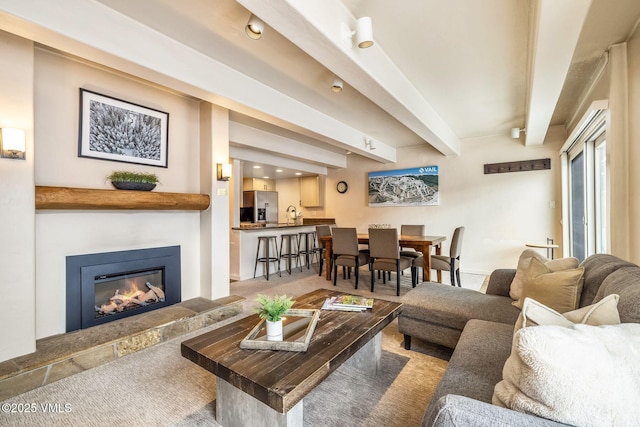 living room with beamed ceiling, carpet flooring, and sink