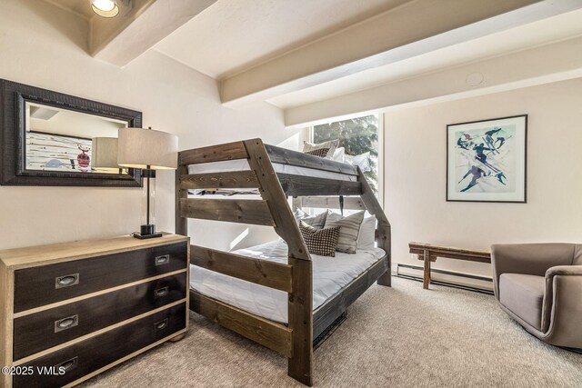 carpeted bedroom featuring a baseboard radiator and beamed ceiling