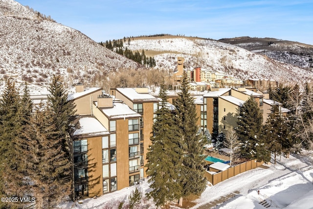 snowy aerial view with a mountain view