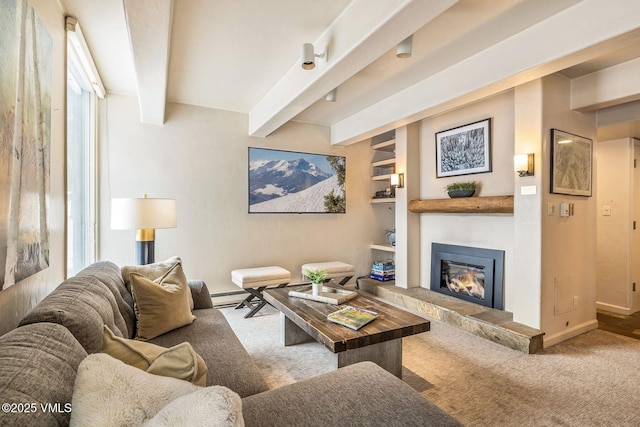 living room featuring carpet, a baseboard heating unit, built in features, and beam ceiling