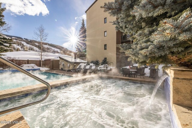 snow covered pool with a mountain view