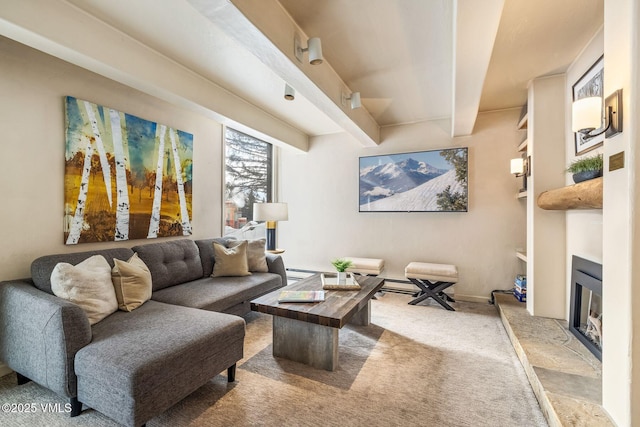 carpeted living room featuring beamed ceiling