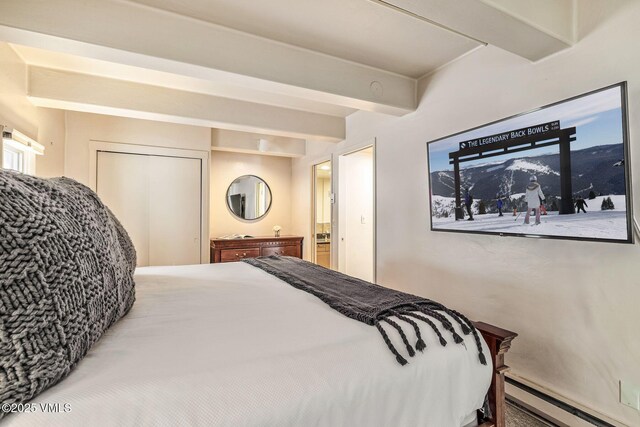 bedroom featuring a mountain view, a baseboard radiator, and beamed ceiling