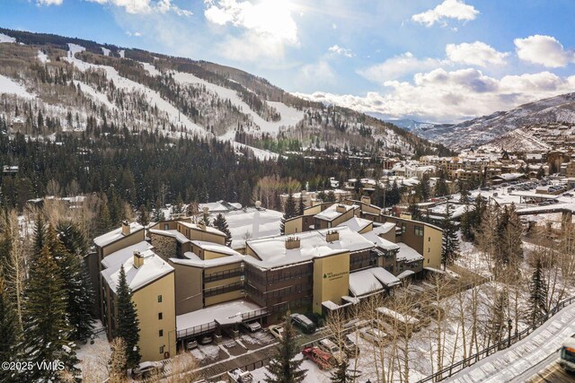 snowy aerial view with a mountain view