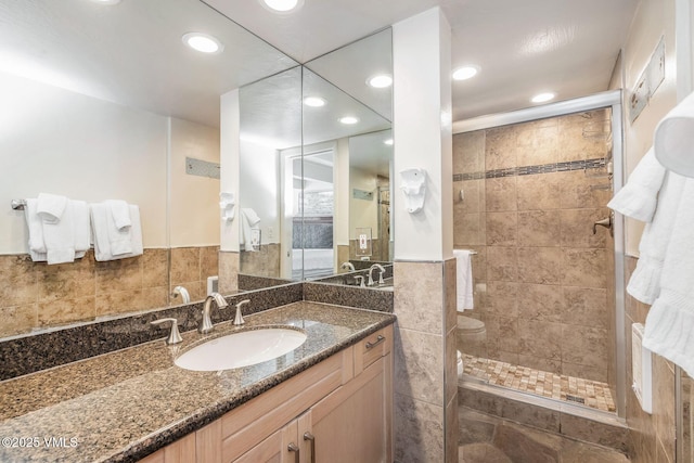 bathroom with vanity and tiled shower