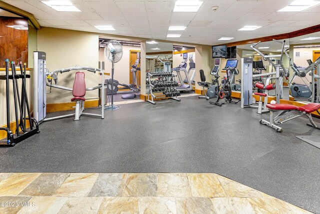 exercise room with a paneled ceiling