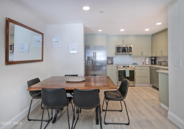 dining space featuring light wood-type flooring