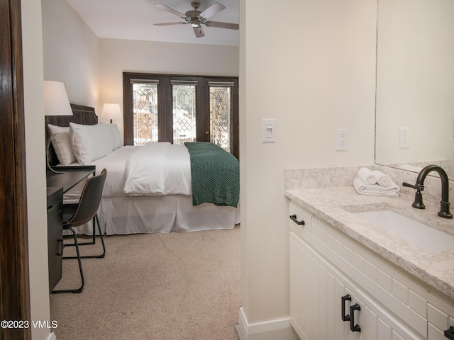 bedroom with sink, light colored carpet, and ceiling fan