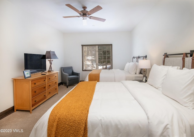 bedroom featuring light colored carpet and ceiling fan