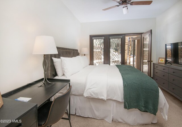 carpeted bedroom featuring lofted ceiling and ceiling fan