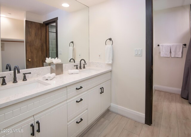 bathroom featuring vanity and wood-type flooring