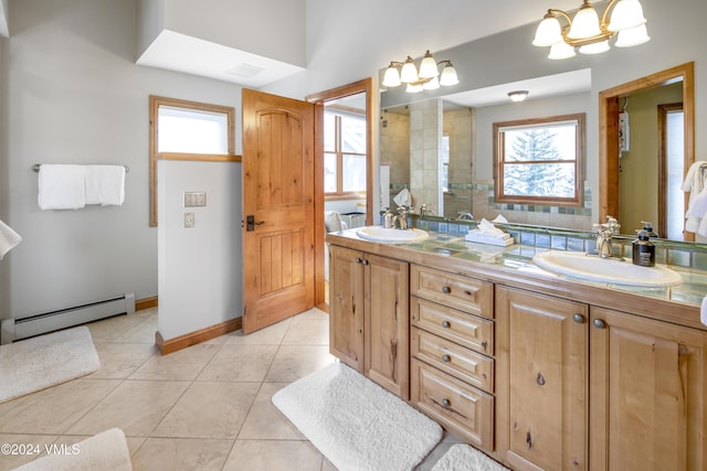 bathroom featuring tiled shower, tile patterned floors, vanity, and a baseboard heating unit