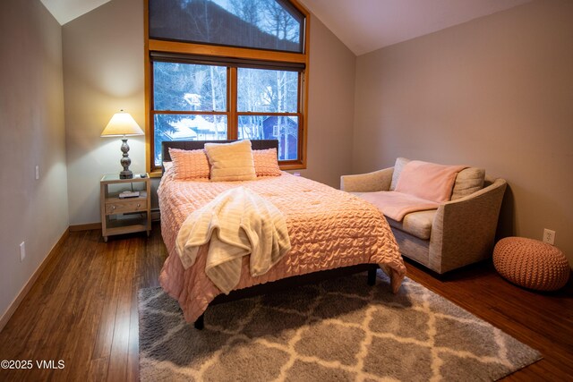 bedroom featuring lofted ceiling and dark hardwood / wood-style flooring