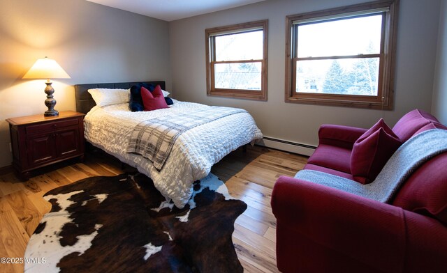 bedroom featuring a baseboard radiator and light wood-type flooring