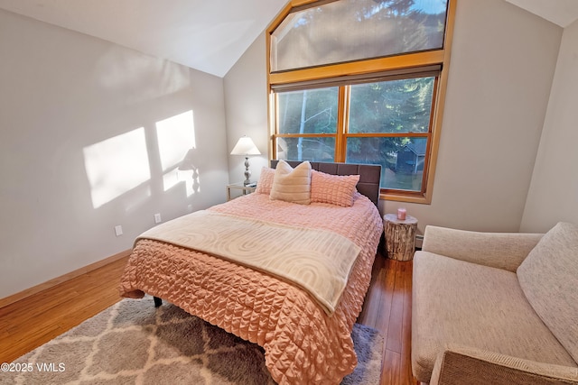 405 Greenwaye Cir Unit 11-A, Eagle-Vail, CO 81620 - bedroom with vaulted ceiling, wood finished floors, and baseboard heating