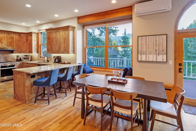 405 Greenwaye Cir Unit 11-A, Eagle-Vail, CO 81620 - dining space with a wall mounted air conditioner, recessed lighting, and light wood-style flooring