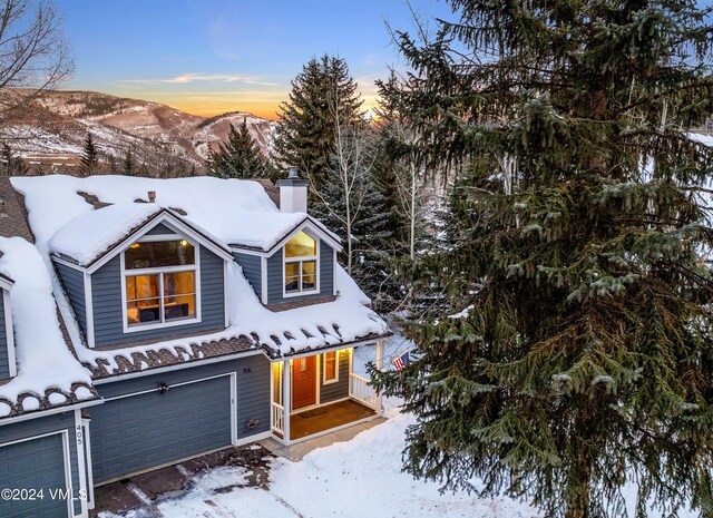 view of front of home with a garage and a mountain view