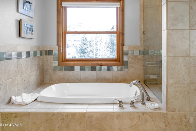 bathroom featuring a relaxing tiled tub