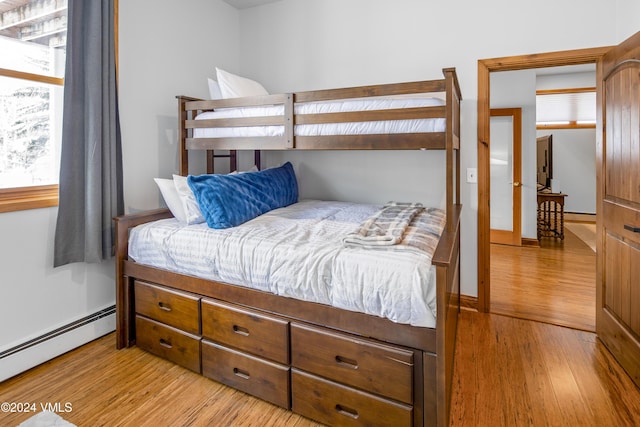 bedroom featuring a baseboard radiator and light wood-type flooring