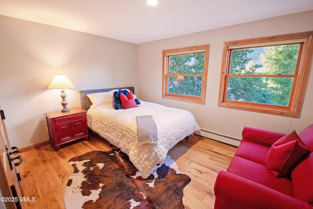 405 Greenwaye Cir Unit 11-A, Eagle-Vail, CO 81620 - bedroom with a baseboard radiator, light wood-style floors, and recessed lighting