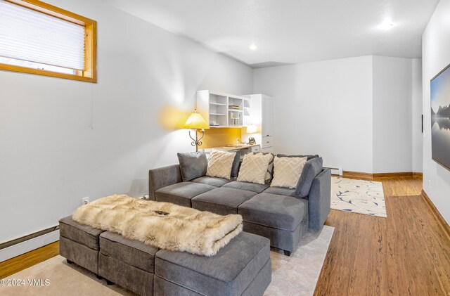 living room featuring a baseboard radiator and light hardwood / wood-style floors