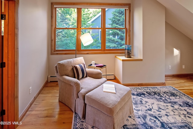 405 Greenwaye Cir Unit 11-A, Eagle-Vail, CO 81620 - living area featuring a baseboard heating unit, light wood-style flooring, and healthy amount of natural light