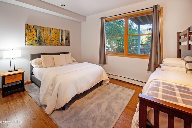 405 Greenwaye Cir Unit 11-A, Eagle-Vail, CO 81620 - bedroom featuring a baseboard radiator and wood finished floors