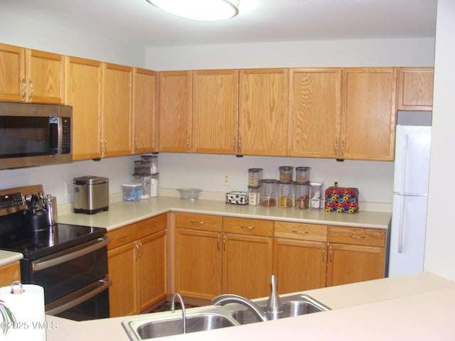 1902 Crazy Horse Cir, Edwards, CO 81632 - kitchen featuring stainless steel appliances, light countertops, and a sink