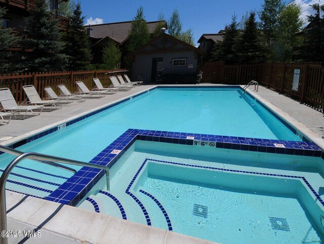 1902 Crazy Horse Cir, Edwards, CO 81632 - view of pool featuring fence, a pool with connected hot tub, and a patio