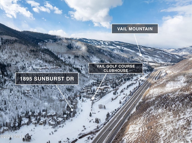 snowy aerial view with a mountain view