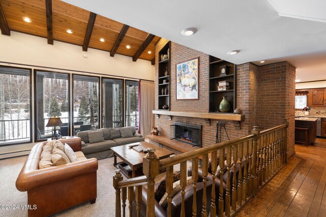 living room featuring beamed ceiling, hardwood / wood-style floors, wood ceiling, and built in shelves