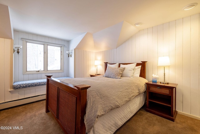 bedroom featuring a baseboard heating unit, vaulted ceiling, and carpet flooring