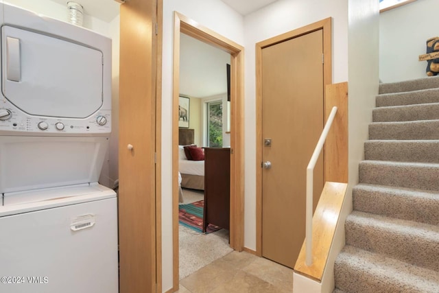 washroom with stacked washer / dryer and laundry area