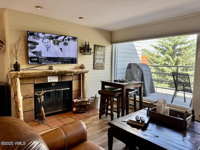1100 N Frontage Rd Unit 1519, Vail, CO 81657 - living room featuring plenty of natural light, wood finished floors, a tiled fireplace, and wood walls